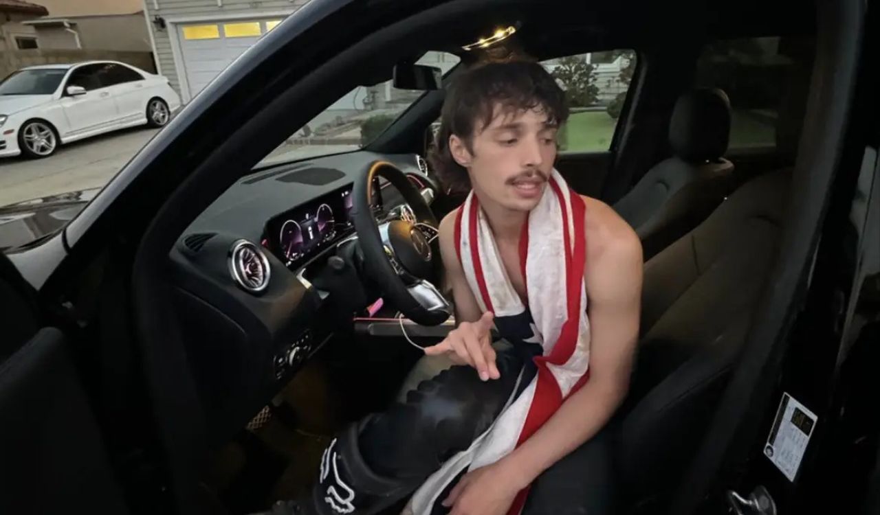 male artist sitting in a car