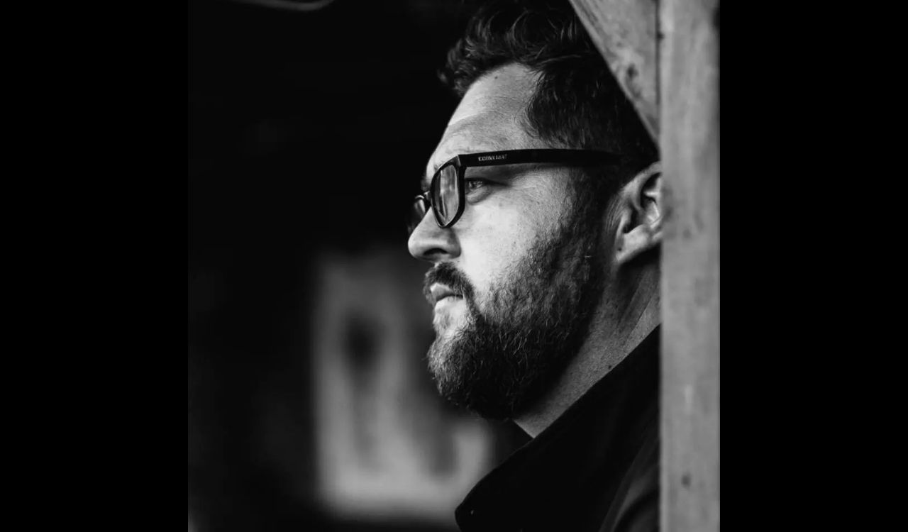 male singer standing in a doorway