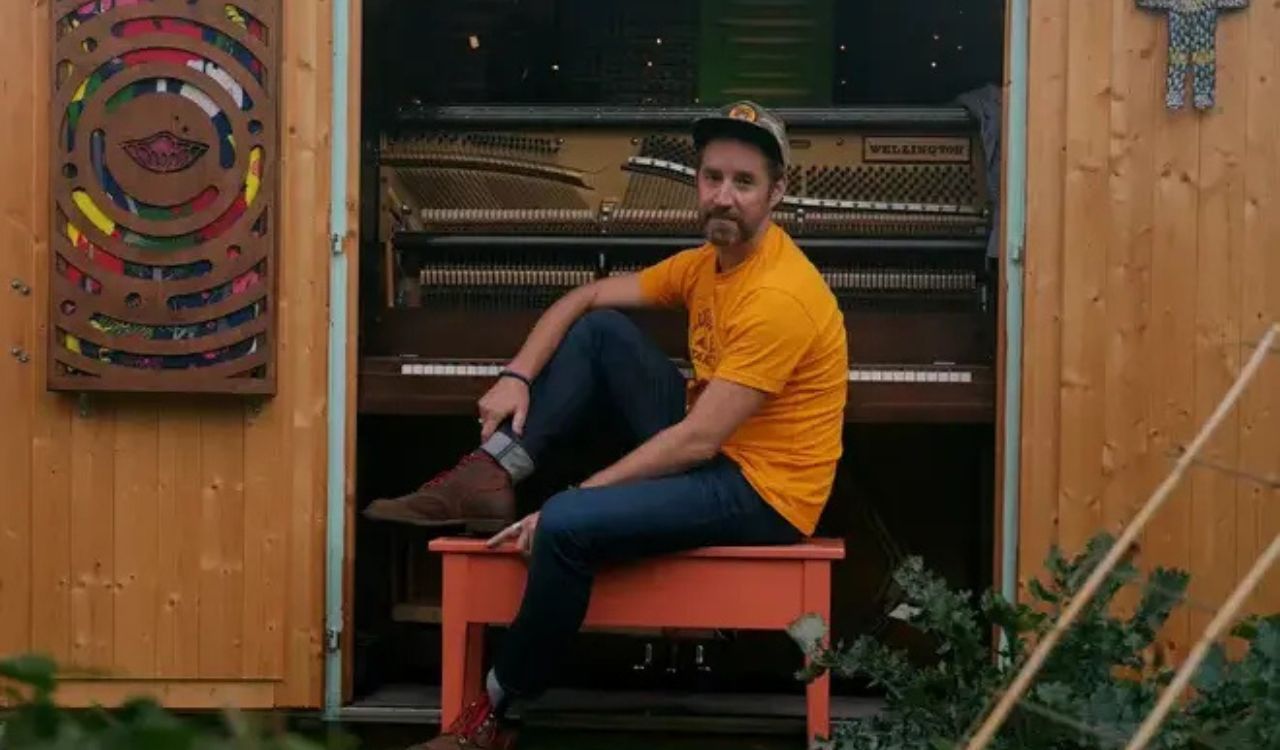 singer sitting at a piano